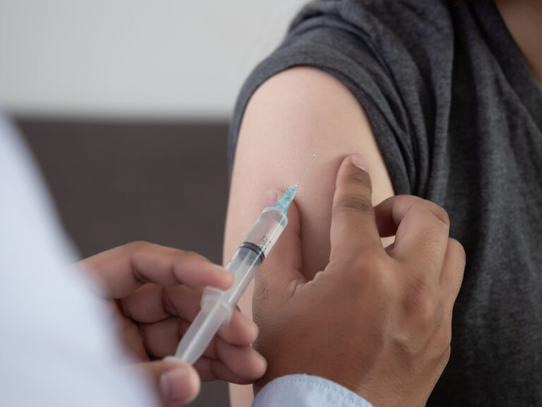 Medicine and health care concept Doctor giving patient vaccine i