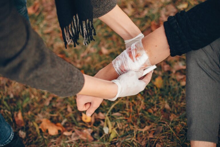 Guy bandages his friend's hand